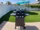 Backyard with artificial turf, grill, and outdoor seating, perfect for entertaining at 4415 S Poplar St, Tempe, AZ 85282
