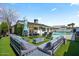 The backyard is designed for relaxing with modern outdoor furniture and pool in the background at 4415 S Poplar St, Tempe, AZ 85282