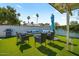 Relaxing backyard oasis with a cozy seating area, fire pit, and lush green synthetic grass at 4415 S Poplar St, Tempe, AZ 85282