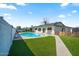 Backyard retreat featuring a swimming pool, patio area, lush lawn, and privacy fence for outdoor enjoyment at 4415 S Poplar St, Tempe, AZ 85282