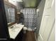 Well-lit bathroom with modern fixtures, stylish mirror, and decorative shower curtain at 4415 S Poplar St, Tempe, AZ 85282