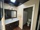Bathroom with a sleek vanity, dark cabinets, and a shower tub combo with a skylight at 4415 S Poplar St, Tempe, AZ 85282
