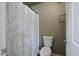 Bathroom features white toilet, shower with curtain, and neutral walls at 4415 S Poplar St, Tempe, AZ 85282