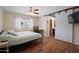 Bedroom with wood-look floors, sliding barn door, window, and closet at 4415 S Poplar St, Tempe, AZ 85282