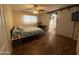 Spacious bedroom features a ceiling fan, dark wood floors, and sliding barn doors at 4415 S Poplar St, Tempe, AZ 85282