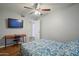 This bedroom includes a desk and ceiling fan and is carpet-free at 4415 S Poplar St, Tempe, AZ 85282