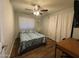Cozy bedroom with ceiling fan, desk and a large window providing bright natural light at 4415 S Poplar St, Tempe, AZ 85282