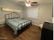 Charming bedroom with dark wood floors, ceiling fan, and a large window with natural light at 4415 S Poplar St, Tempe, AZ 85282