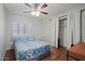 Cozy bedroom with blue comforter, ceiling fan and large window for natural light at 4415 S Poplar St, Tempe, AZ 85282