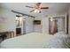 Bedroom with wood-look floors, sliding barn door, window, and closet at 4415 S Poplar St, Tempe, AZ 85282