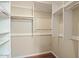 Walk-in closet with built-in shelving and wooden floors at 4415 S Poplar St, Tempe, AZ 85282