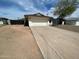 Single story home with a two car garage and a low maintenance desert landscape at 4415 S Poplar St, Tempe, AZ 85282
