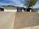 Well-maintained single-story home featuring a two car garage and desert landscaping at 4415 S Poplar St, Tempe, AZ 85282