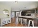 The kitchen has dark cabinets, stainless appliances, a peninsula, and hardwood floors at 4415 S Poplar St, Tempe, AZ 85282