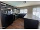 Modern kitchen featuring stainless steel appliances, dark cabinets, and bright countertops at 4415 S Poplar St, Tempe, AZ 85282