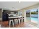 Open kitchen features a breakfast bar with seating and sliding doors to pool area at 4415 S Poplar St, Tempe, AZ 85282
