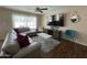 Cozy living room with stylish decor, a large screen TV, and comfortable seating at 4415 S Poplar St, Tempe, AZ 85282