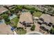 Bird's eye view showing a beautiful backyard with a pool, putting green, and sports court perfect for outdoor enjoyment at 4463 S Oregon Ct, Chandler, AZ 85248