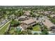 Aerial view of a community, highlighting a home with a private pool, putting green, and a sports court at 4463 S Oregon Ct, Chandler, AZ 85248