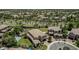 Overhead view highlights a home with a basketball court, pool, putting green, and lush greenery in a suburban neighborhood at 4463 S Oregon Ct, Chandler, AZ 85248
