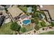 Sprawling backyard features a pool, putting green, sports court, mature trees, and lush landscaping at 4463 S Oregon Ct, Chandler, AZ 85248