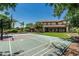 Spacious backyard with a basketball court, patio, lush grass, and mature trees at 4463 S Oregon Ct, Chandler, AZ 85248
