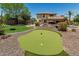 This backyard features a putting green, patio, and landscaping perfect for outdoor activities and relaxation at 4463 S Oregon Ct, Chandler, AZ 85248