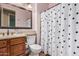 Bathroom featuring single vanity, a large mirror and a polka dot shower curtain at 4463 S Oregon Ct, Chandler, AZ 85248