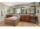 Bright bathroom featuring dual vanities, soaking tub, and tile flooring at 4463 S Oregon Ct, Chandler, AZ 85248