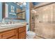 Beautiful bathroom featuring tiled shower with glass door, granite countertops, and blue walls at 4463 S Oregon Ct, Chandler, AZ 85248