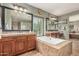 Elegant bathroom features a soaking tub, dual vanities and tiled shower at 4463 S Oregon Ct, Chandler, AZ 85248