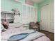Charming bedroom features a sliding barn door bookshelf, shuttered windows, and a cozy chair at 4463 S Oregon Ct, Chandler, AZ 85248