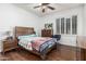 Bedroom featuring hardwood floors, a ceiling fan and window shutters at 4463 S Oregon Ct, Chandler, AZ 85248