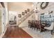 Inviting dining room featuring staircase, wood floors, chandelier, and accent wall with built-in storage at 4463 S Oregon Ct, Chandler, AZ 85248