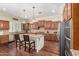Open kitchen boasts a center island with bar seating, granite countertops, and stainless steel appliances at 4463 S Oregon Ct, Chandler, AZ 85248
