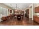 Spacious open-concept kitchen and dining area featuring hardwood floors, custom cabinetry, and stainless appliances at 4463 S Oregon Ct, Chandler, AZ 85248