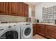 Convenient laundry room with updated appliances, cabinetry, and utility sink at 4463 S Oregon Ct, Chandler, AZ 85248