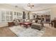 Comfortable living room featuring a large sectional sofa, natural light, and access to kitchen at 4463 S Oregon Ct, Chandler, AZ 85248