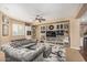 Cozy living room features a plush sectional sofa, built-in bookshelves, and a ceiling fan at 4463 S Oregon Ct, Chandler, AZ 85248