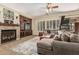 A spacious living room with a stone fireplace, entertainment center, and large sectional sofa at 4463 S Oregon Ct, Chandler, AZ 85248