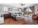 Bright main bedroom with balcony access, hardwood floors, and comfortable seating area at 4463 S Oregon Ct, Chandler, AZ 85248