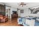 A spacious main bedroom with hardwood floors, a decorative dresser, and a comfortable seating area at 4463 S Oregon Ct, Chandler, AZ 85248