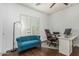 Bright home office space with white walls, an accent couch, and a large window with plantation shutters at 4463 S Oregon Ct, Chandler, AZ 85248