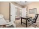 Comfortable office space with a dark wood desk, leather chair, and neutral carpet at 4463 S Oregon Ct, Chandler, AZ 85248