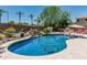 A backyard pool featuring a rock waterfall and plenty of room to relax poolside at 4463 S Oregon Ct, Chandler, AZ 85248