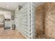 Modern shower featuring glass block partition and decorative tile work at 4463 S Oregon Ct, Chandler, AZ 85248
