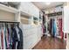 Spacious walk-in closet with custom built-in shelving, cabinets, and drawers for optimal organization and storage at 4463 S Oregon Ct, Chandler, AZ 85248