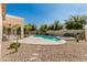 Spacious backyard oasis featuring a pool, spa, desert landscaping, and covered patio for relaxation and entertainment at 4520 N 151St Dr, Goodyear, AZ 85395
