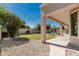 Inviting backyard featuring a covered patio, lush green lawn, and a sparkling pool, perfect for outdoor entertaining at 4520 N 151St Dr, Goodyear, AZ 85395