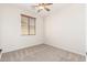 Bedroom featuring soft carpet, a ceiling fan, and a window with blinds at 4520 N 151St Dr, Goodyear, AZ 85395